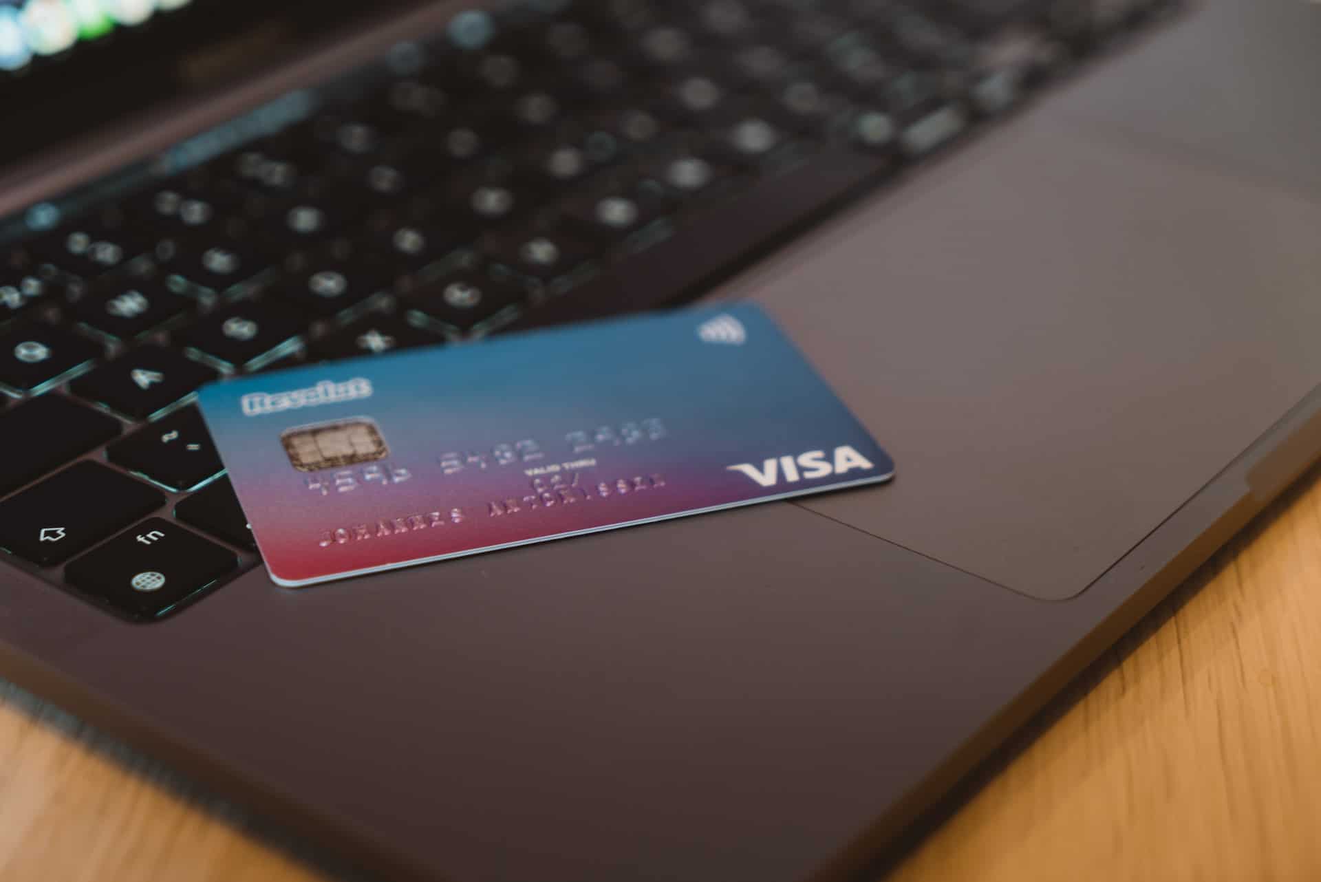 credit card laying on top of a laptop
